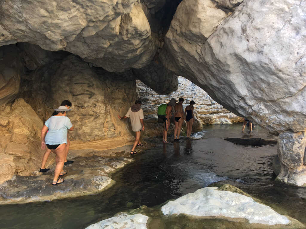 A group of French tourists at the beginning of the hike through the lower part of Wadi Bani Khalid, Oman.
